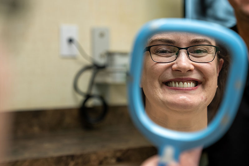 Woman looking into mirror