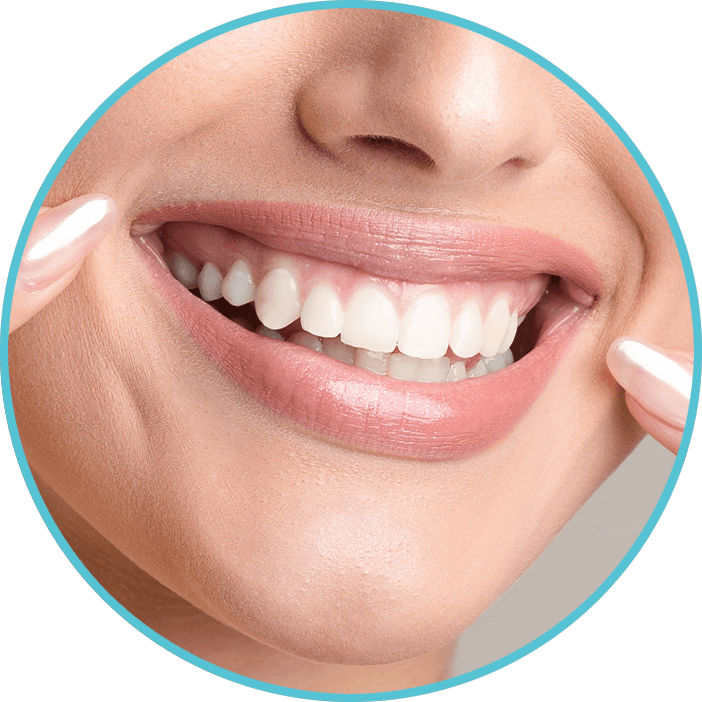 woman pointing at her freathly whitened teeth