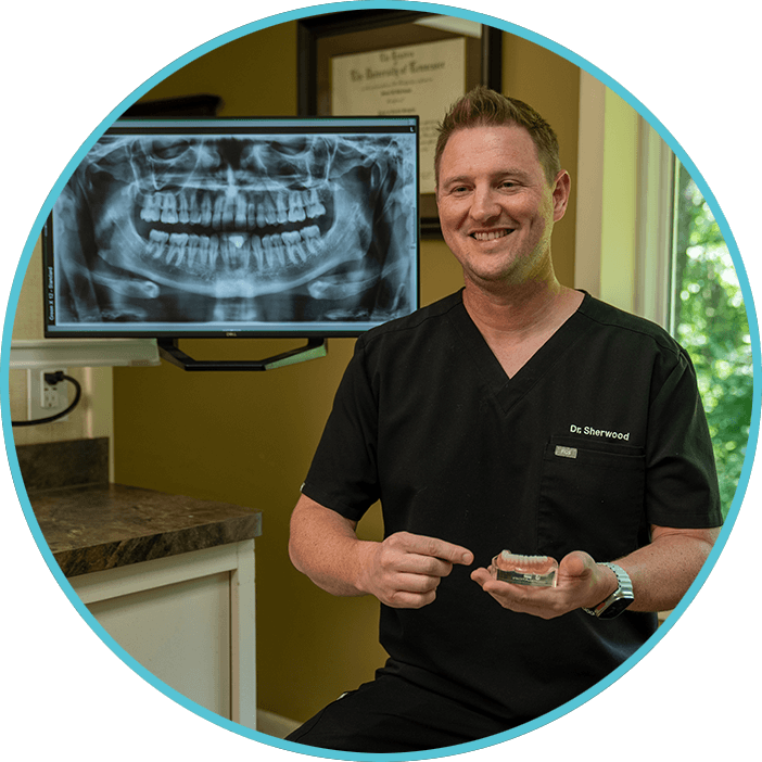 Doctor Holding a model of dental implants