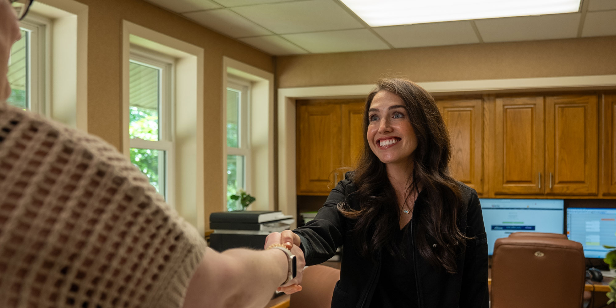 team member greeting Patient into the dental office