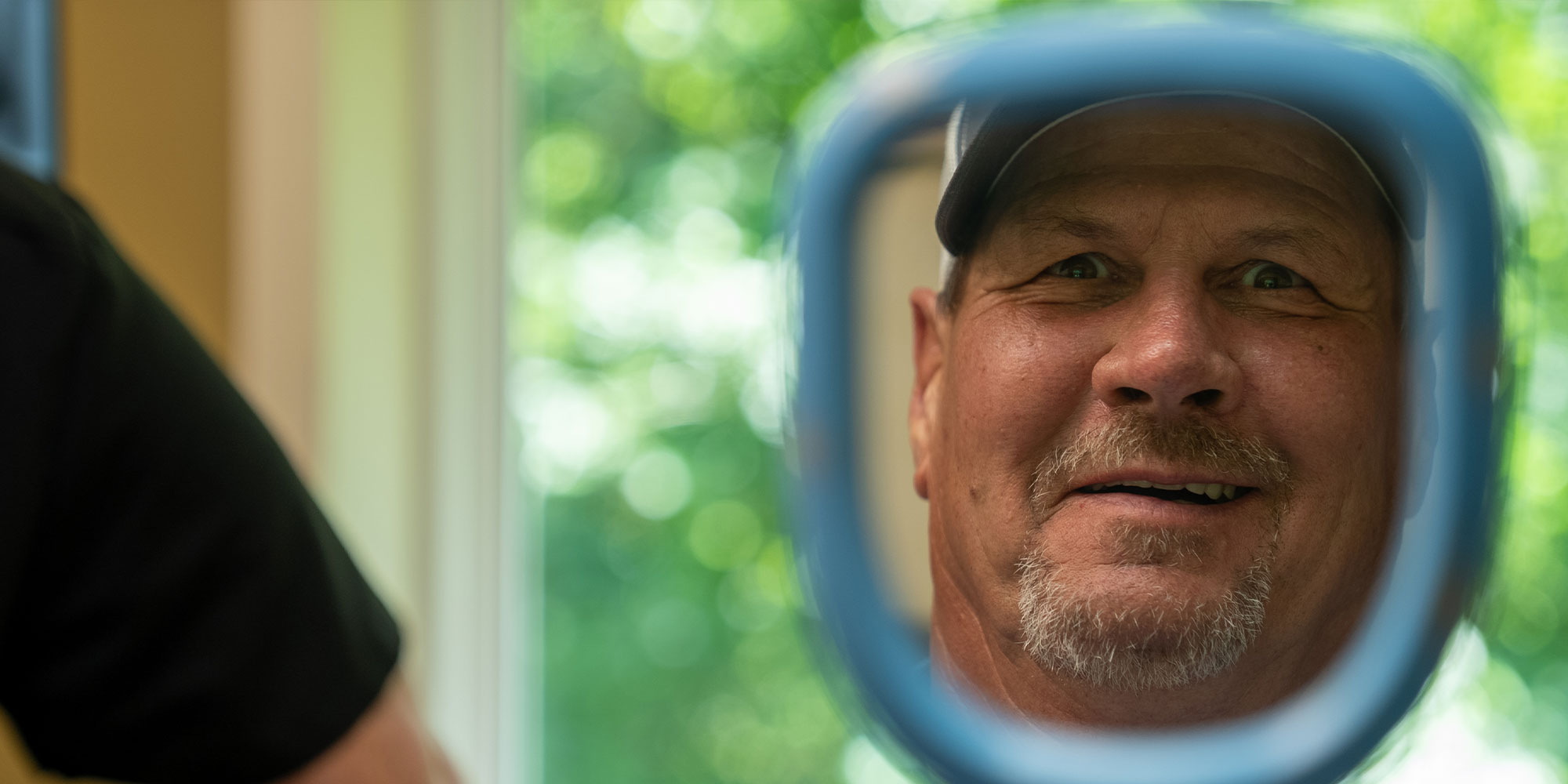 Patient looking into mirror smiling