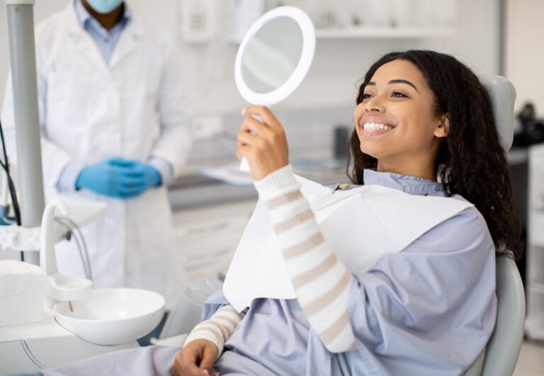Dentist consulting patient about bleeding gums in modern dental office.